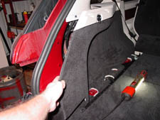 remove the panel in the left rear of the cargo area